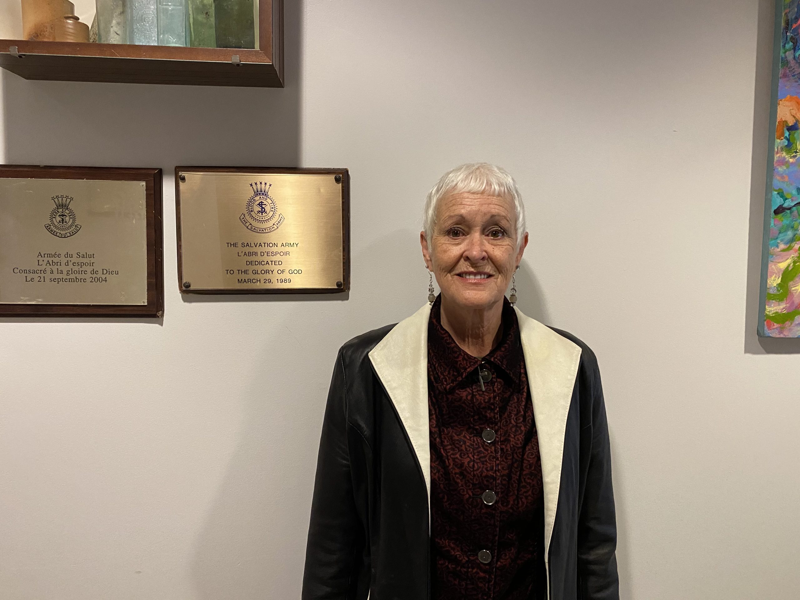 woman smiling in front of plaques