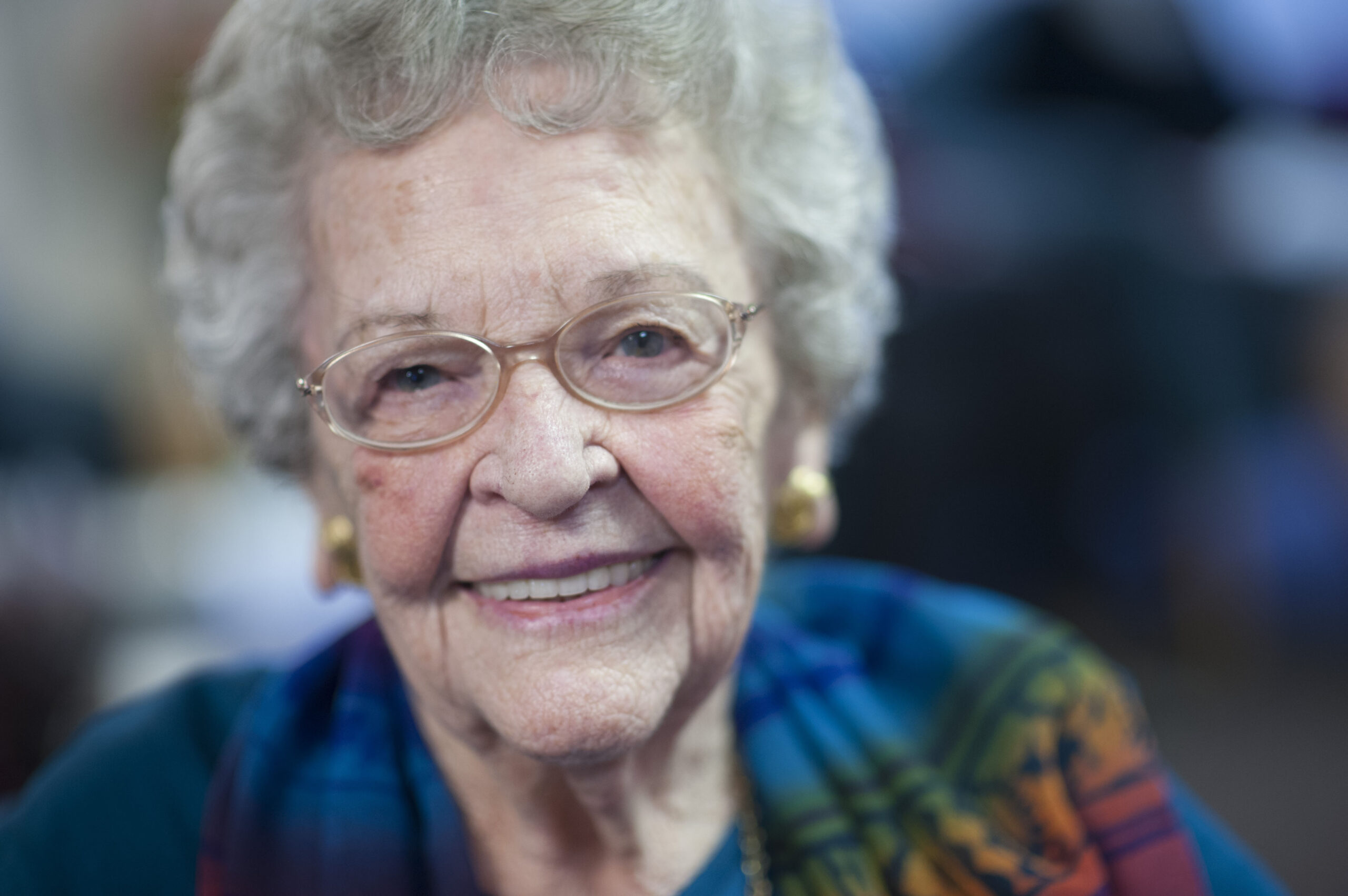 Elderly woman smiles at the camera