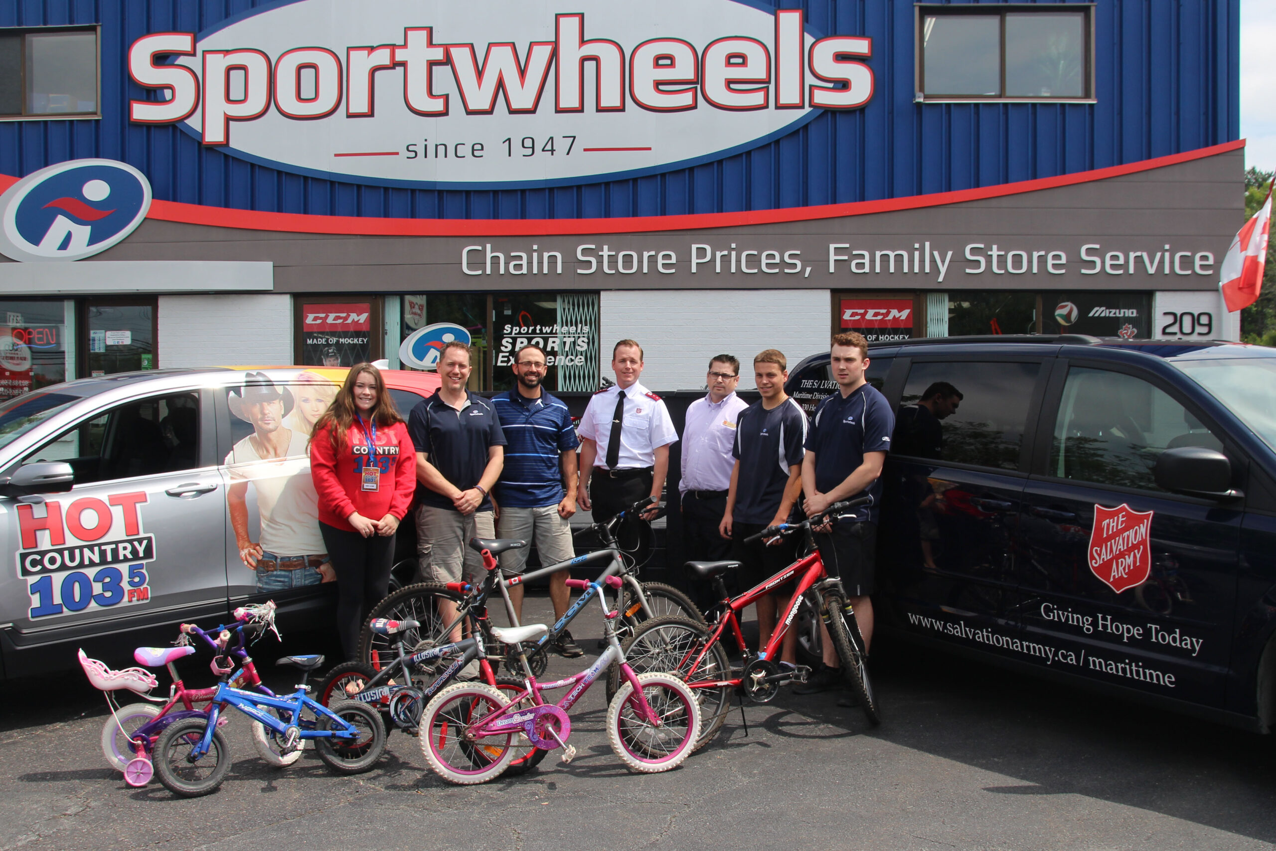 group of people and bikes in fron tof sportwheels