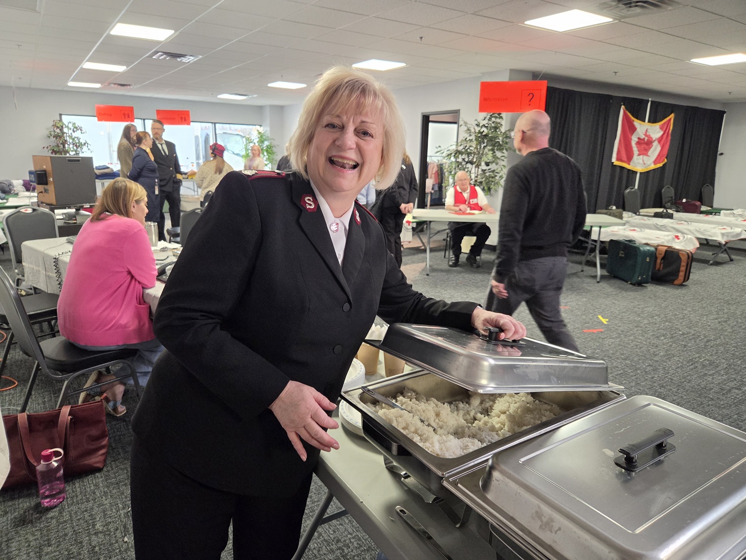 Major Pam Goodyear serves food at reception centre