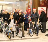 Men, women and children donate bikes to toy mountain