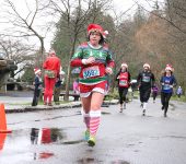 Participants in festive gear run in wet weather