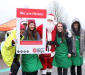 Participants photo with Santa and sign "I am a Hero"