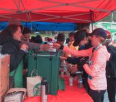 Santa Shuffle participants get water at tent