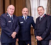 Three men in Salvation Army uniforms smiling