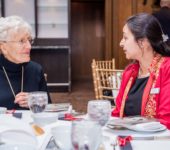 Two women talking at table