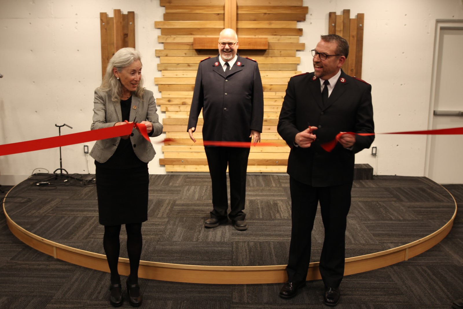 two people cutting the ribbon