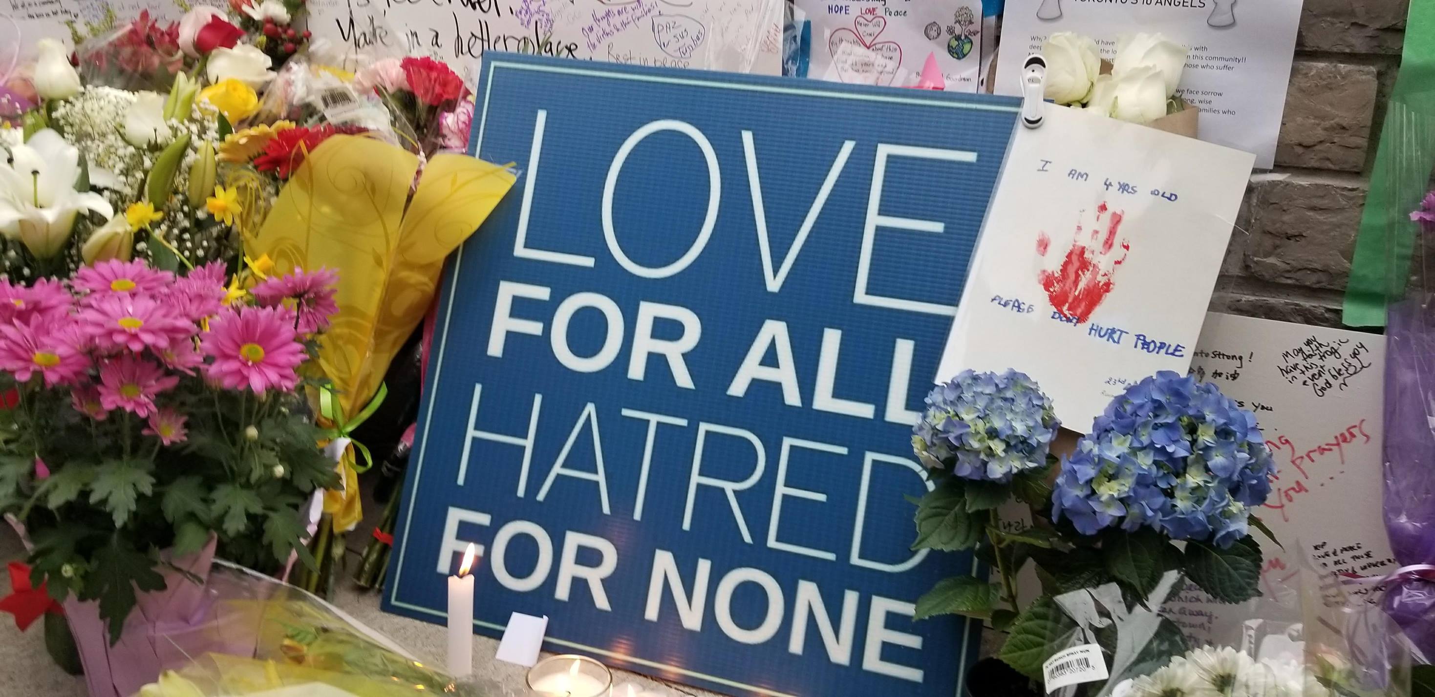 A sign that reads 'Love for all, hatred for none' at Vigil for Toronto victims.