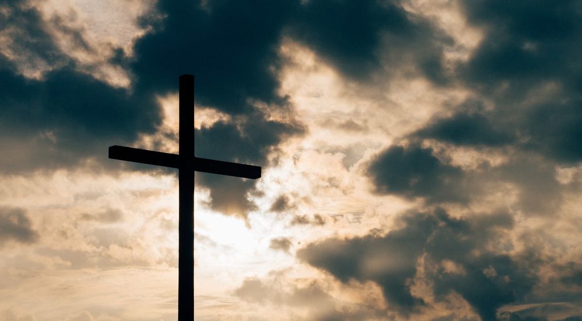 Photo of a cross during sunset