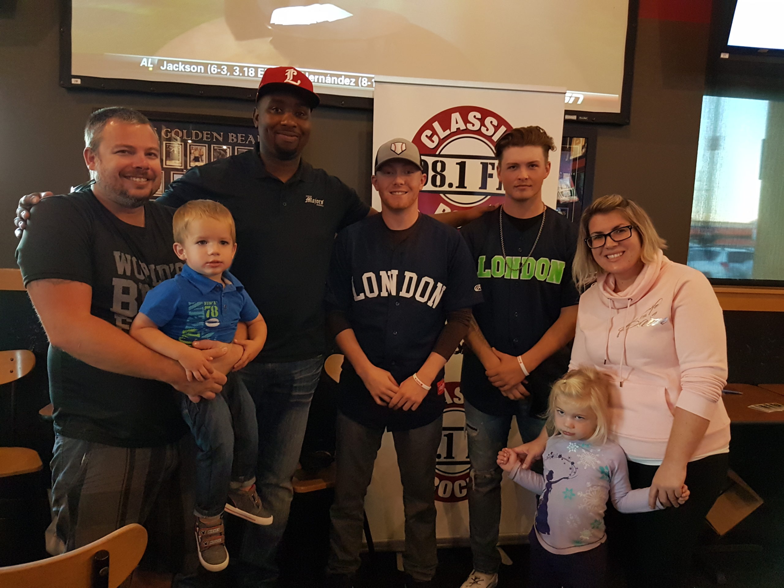 men, woman, and two children posing at buffalo wild wing