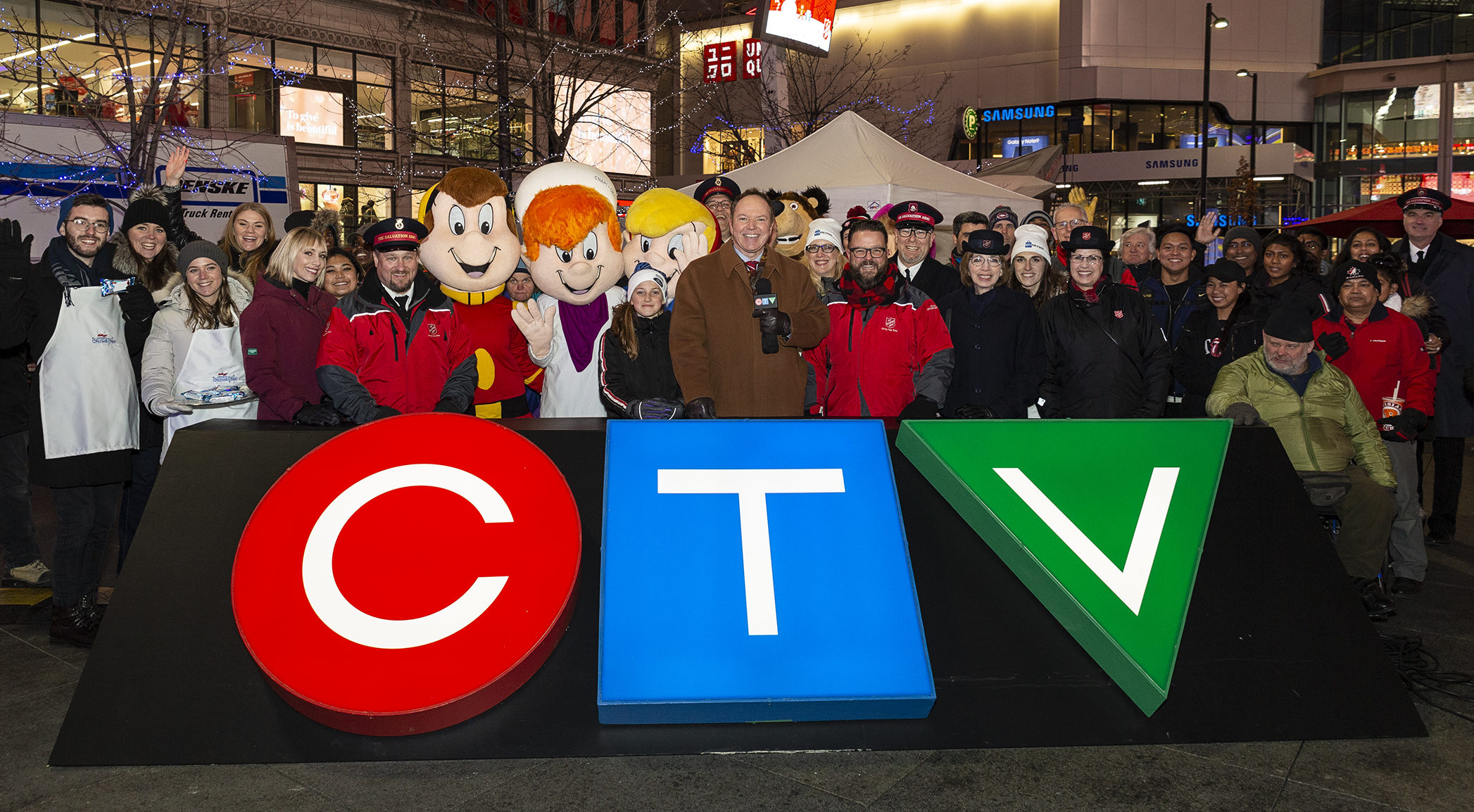 Toy Mountain team and supporters gather at the CTV sign