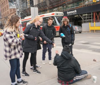 Youth Group handing out coffee to an individual on the street