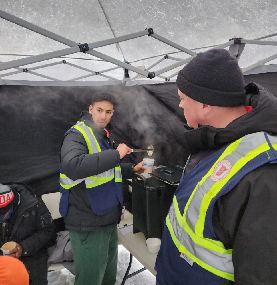 Renato serves a hot chocolate to visitors of the Salvation Army warming station in Calgary, AB.