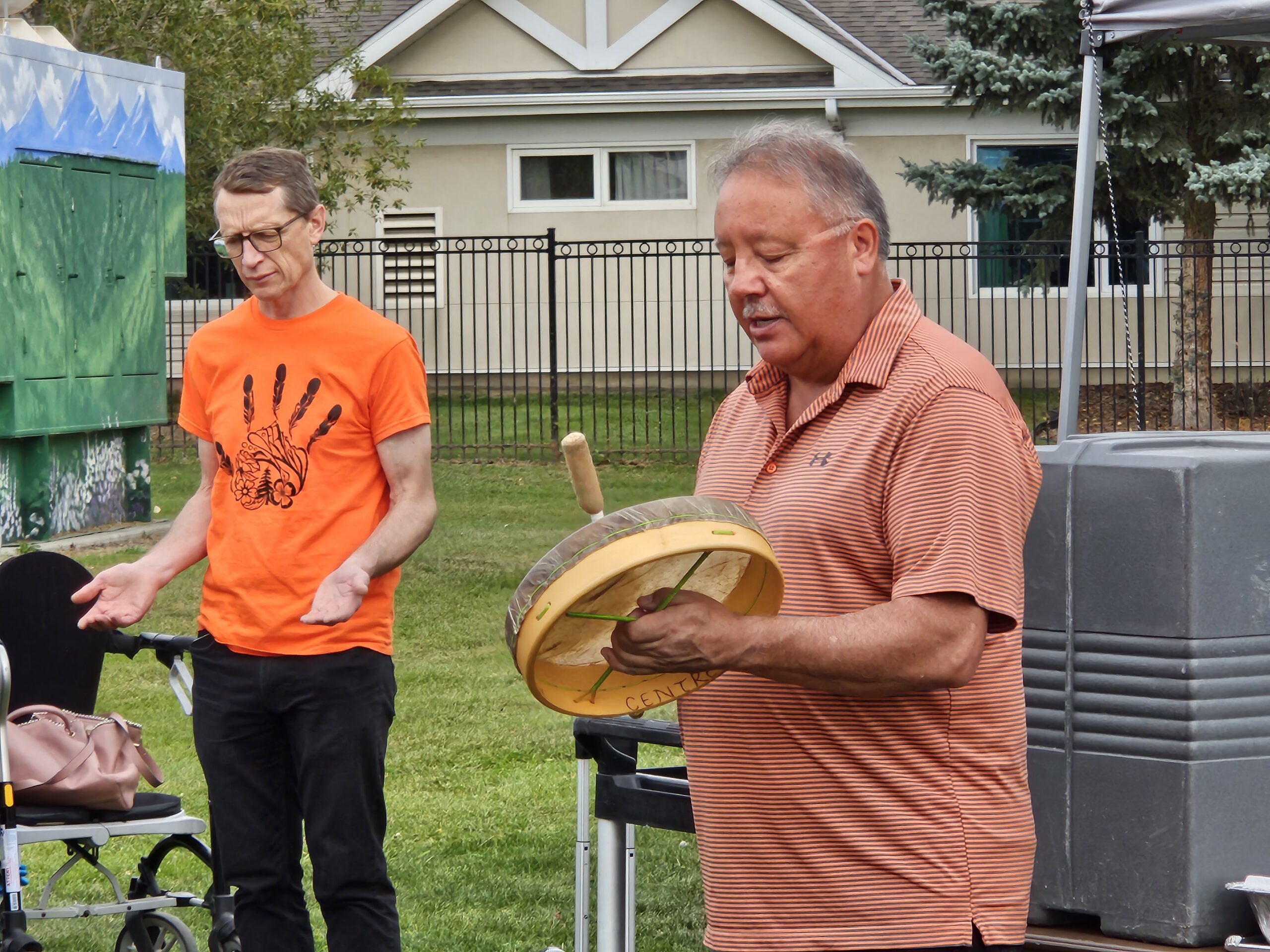 Elder Harold sings a song with Chaplain John in the background at Grace Village