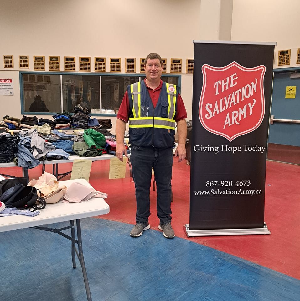 Team member stands with donations