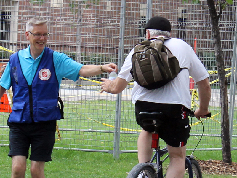 Arthur Heathcote hands water to a thirsty cyclist