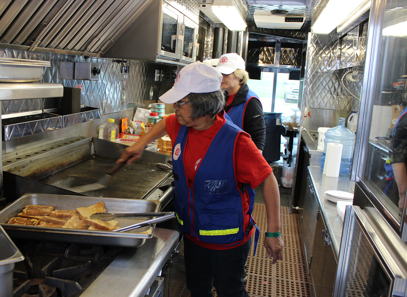 EDS cooks preparing a meal on the EDS van