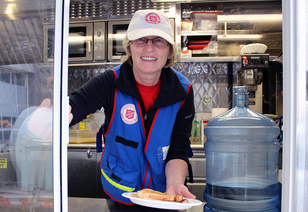 EDS worker serving food through van window