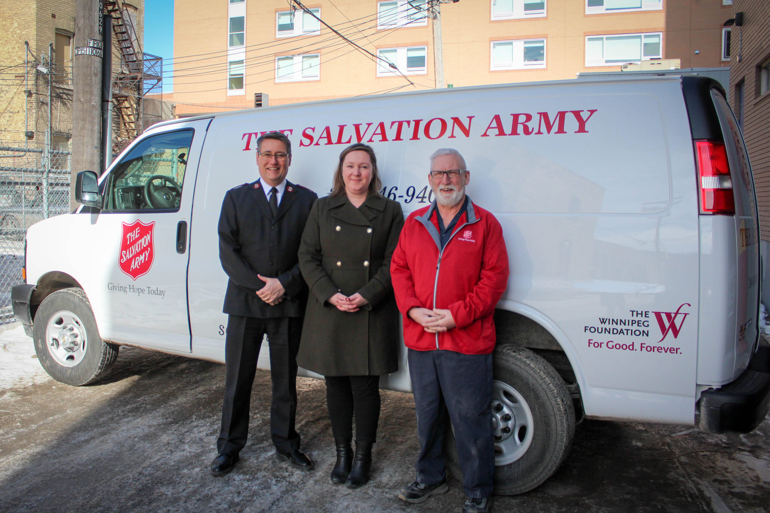 3 people pose in front of new van