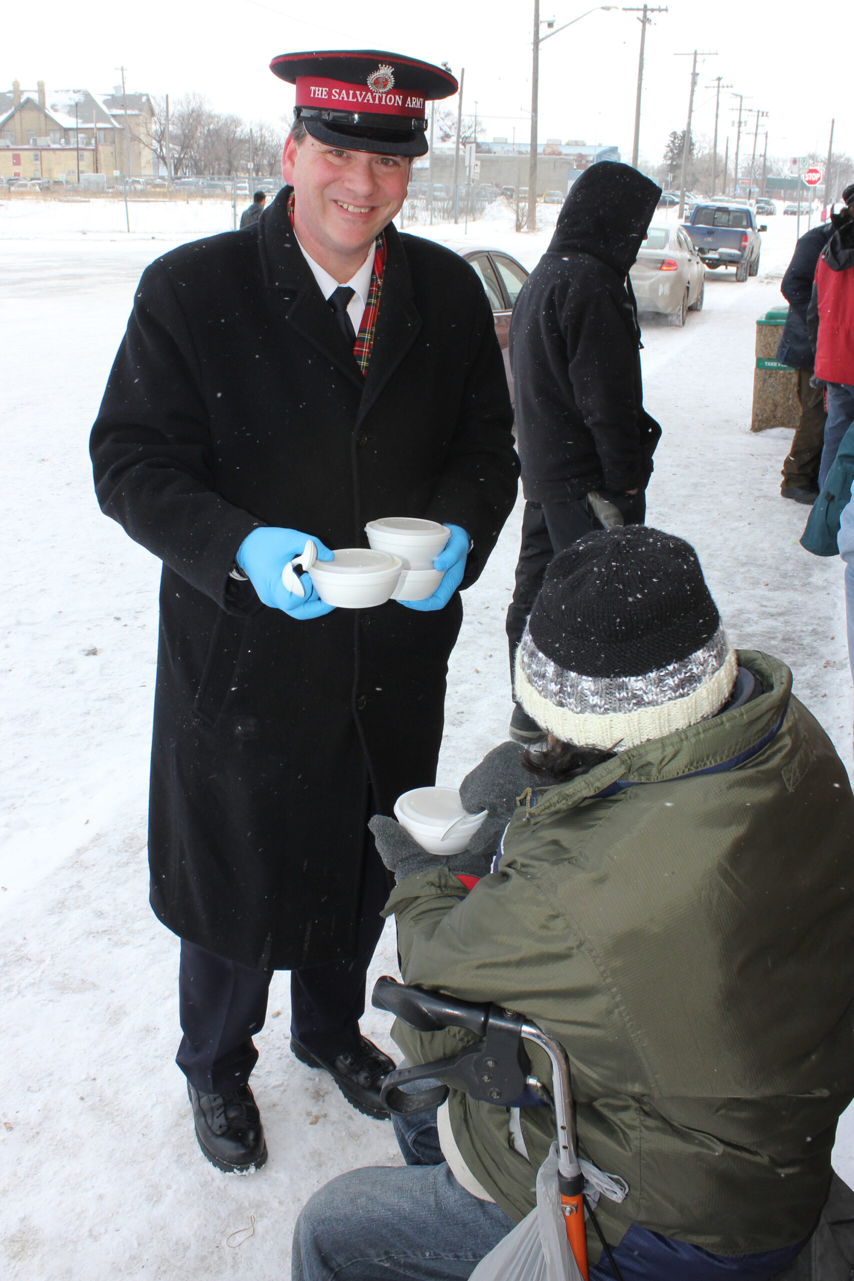 Capt. Rod Bungay offers a bowl of soup to a man in need