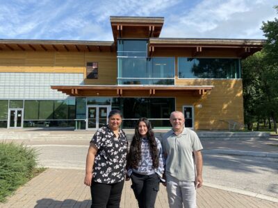 a family standing in front of a building