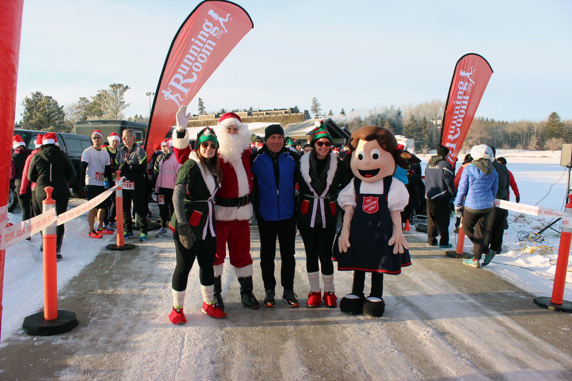 John Stanton, founder of the Running Room with Santa & his Elves, and Sally Ann at the 25th Santa Shuffle in Edmonton.