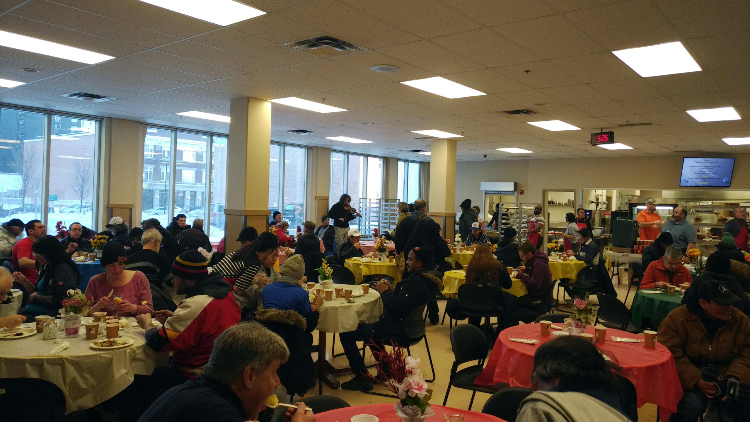 People enjoying a free turkey dinner at the Annual Family Day Community Meal in Calgary.