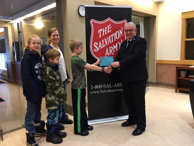 salvation army officer donating a gift to a family