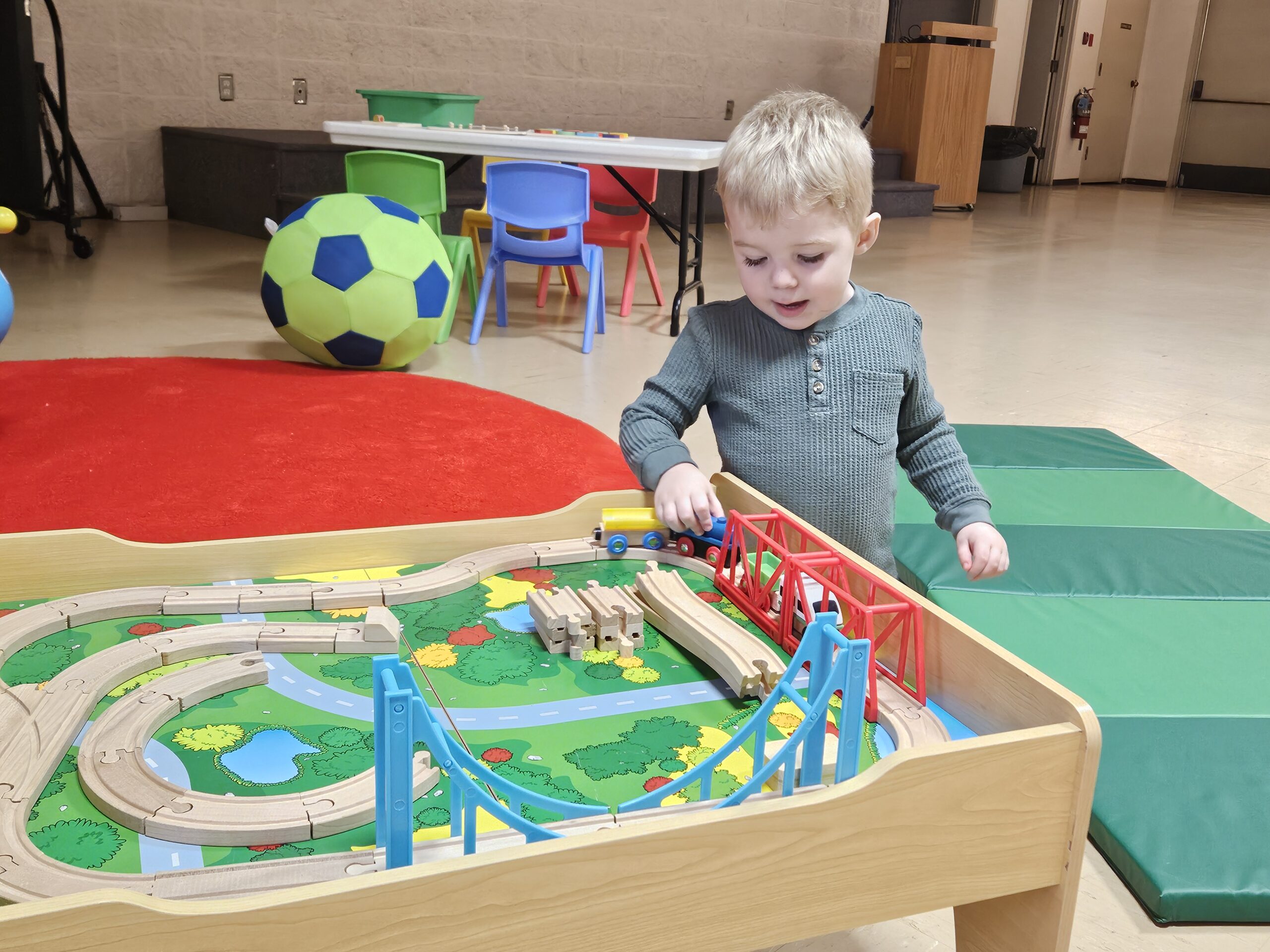 Child plays with toys at Edmonton Temple's Play Cafe