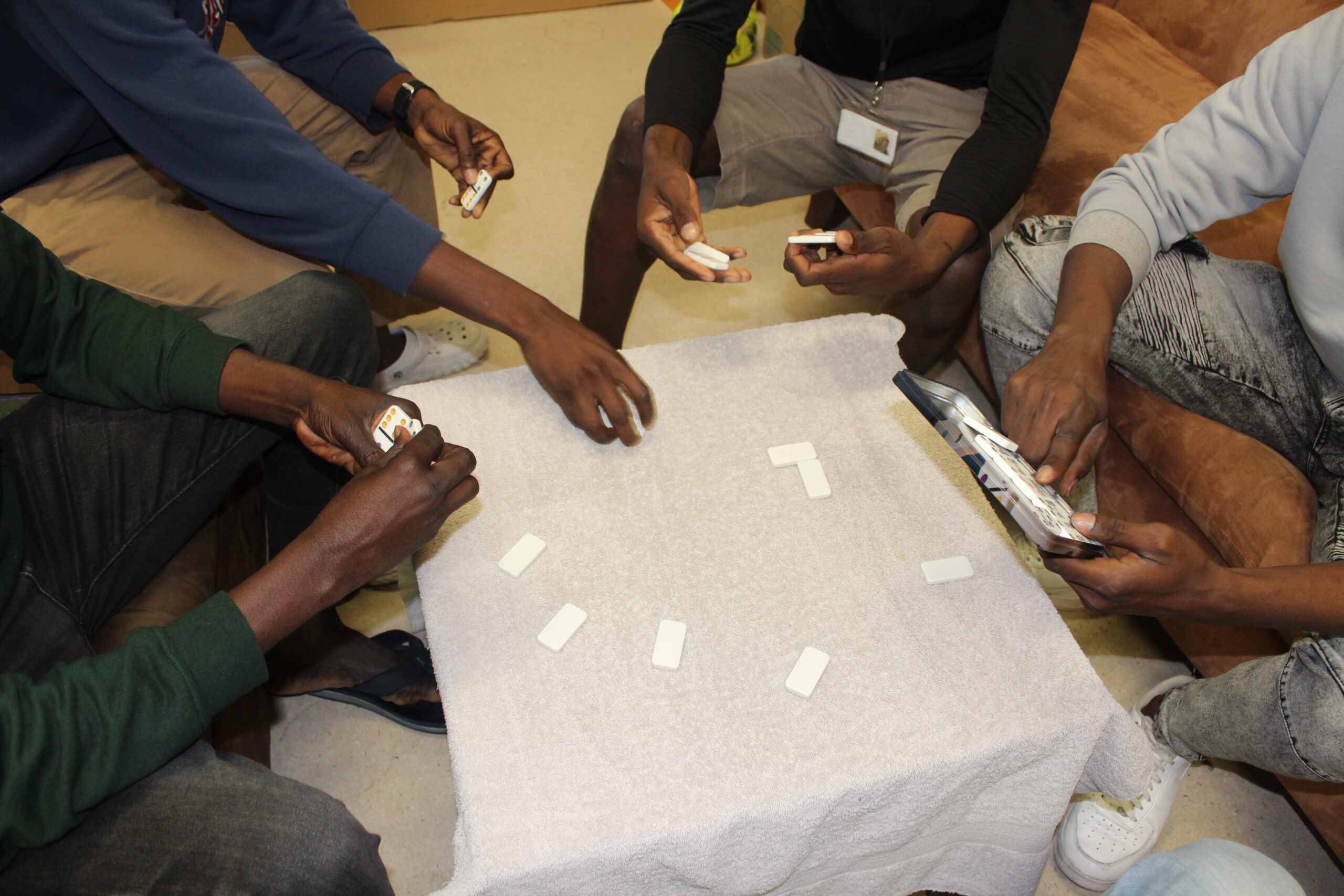 A group of men playing dominoes