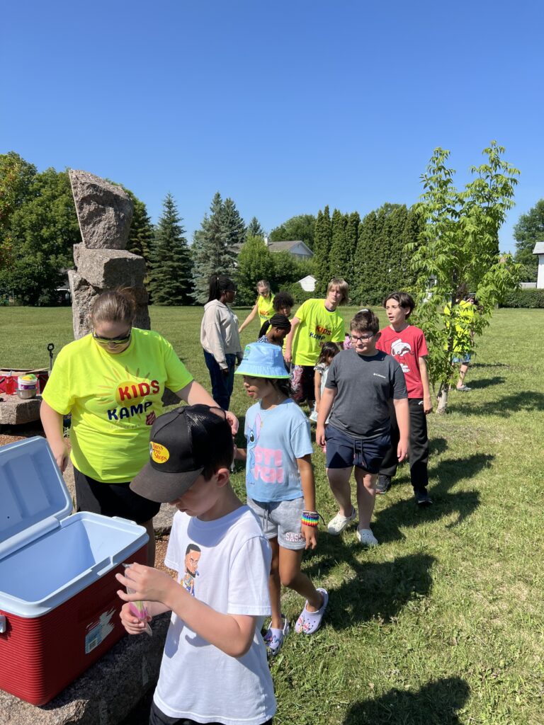Children in line receiving popsicles