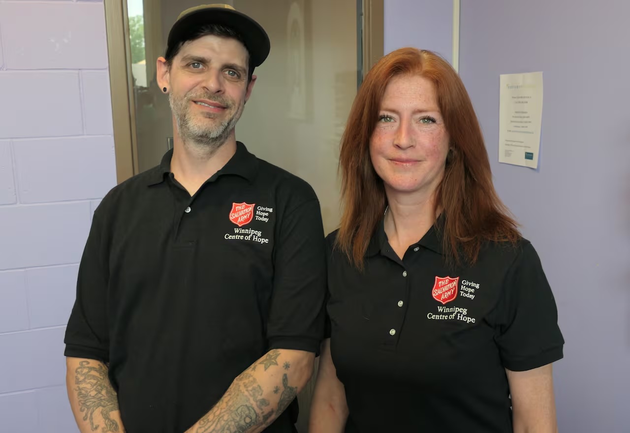 Two outreach workers wearing Salvation Army shirts