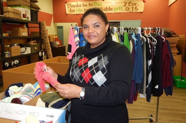 Antoinette chooses Christmas presents for her children at The Salvation Army's Community and Family Services in Markham, Ont.