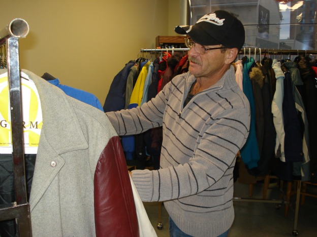 Male recipient chooses a warm coat in Belleville, Ont.