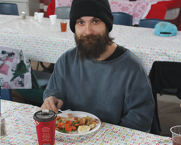 Travis - Travis enjoys a meal provided by the Salvation Army