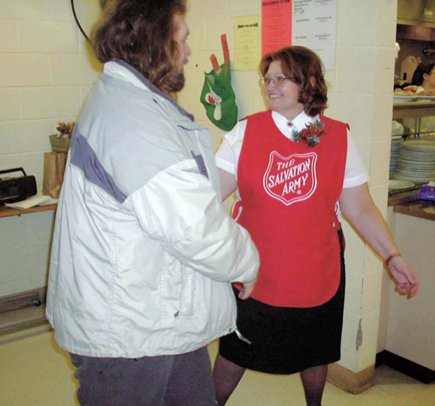 Salvation Army worker welcomes guest for Christmas meal