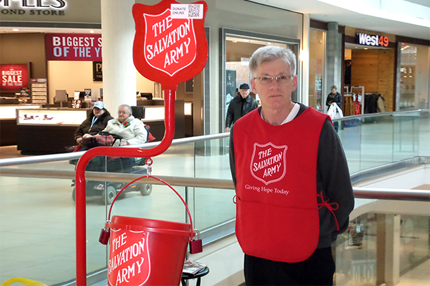 Volunteer, Rod McMullin, stands at a kettle to collect funds for The Salvation Army's work