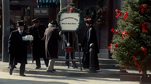 Actors around a Salvation Army donation kettle on the set of the 2016 Murdoch Mysteries Christmas special. Photo compliments of CBC.