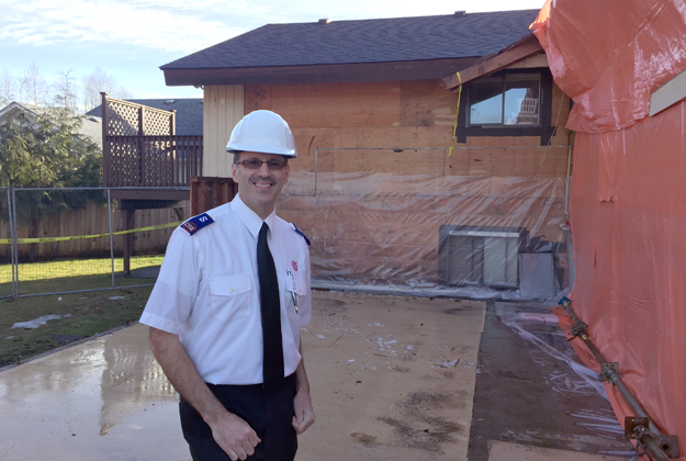 Brent Hobden, community ministries director, stands in front of shelter expansion construction