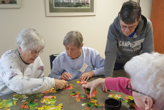 Agnes and friends do puzzles at London's adult day care centre