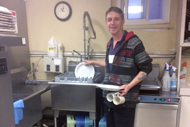 Rob volunteers and washes dishes in the kitchen at The Salvation Army's Booth Centre in St. Catherines, Ont.