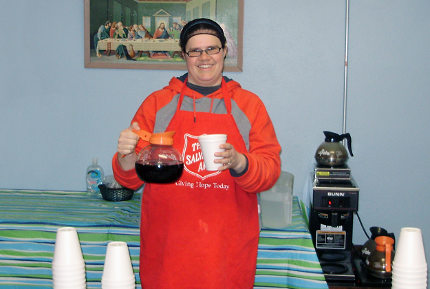 Volunteer, Tiffany, serves coffee and beverages at community lunch program in Pembroke