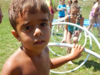 Young camper enjoys water day at summer camp