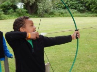 Learning archery at summer camp