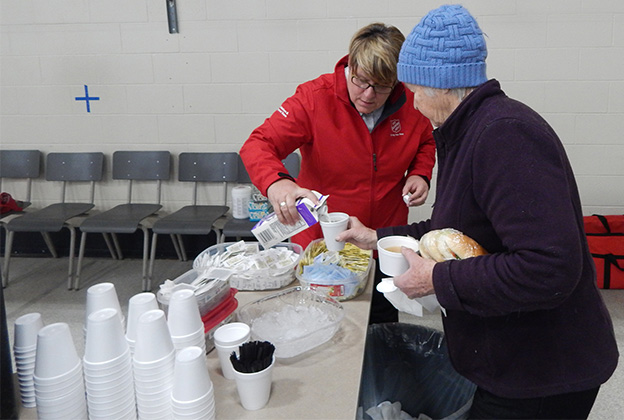 Homeless senior receives food and hydration from Salvation Army