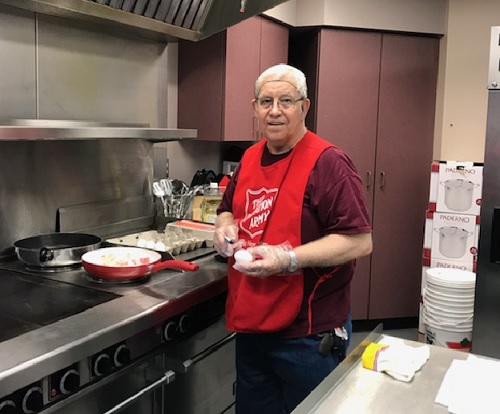 Volunteer prepares meals to serve to flood victims