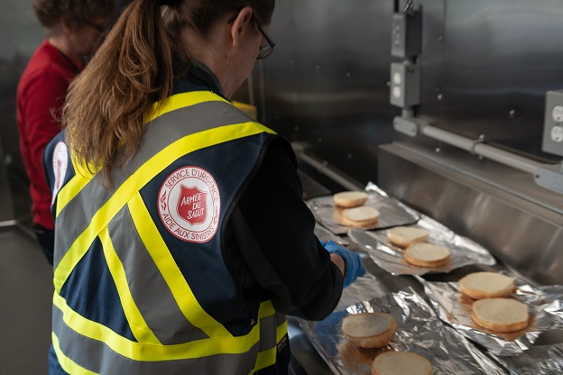 Salvation Army Emergency Disaster personnel serve hot meals to those without power and first responders