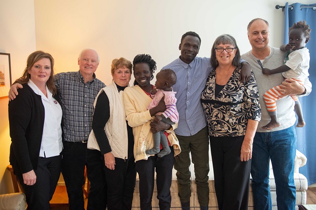 Both and family stand with some members of The Salvation Army's sponsorship team