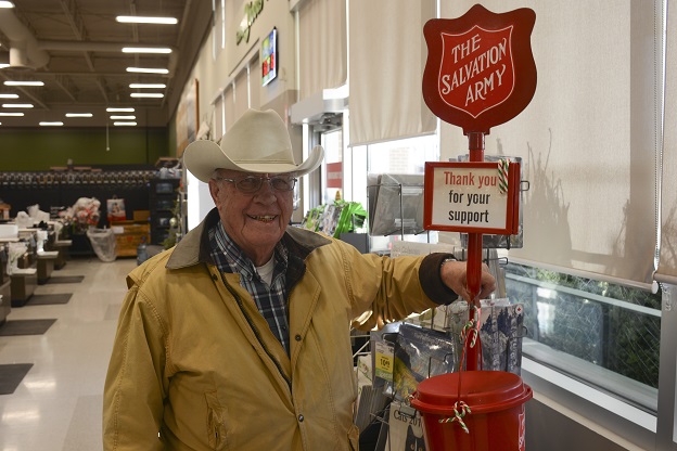 A smiling Stu Bradley mans a Salvation Army kettle in Cochrane, AB