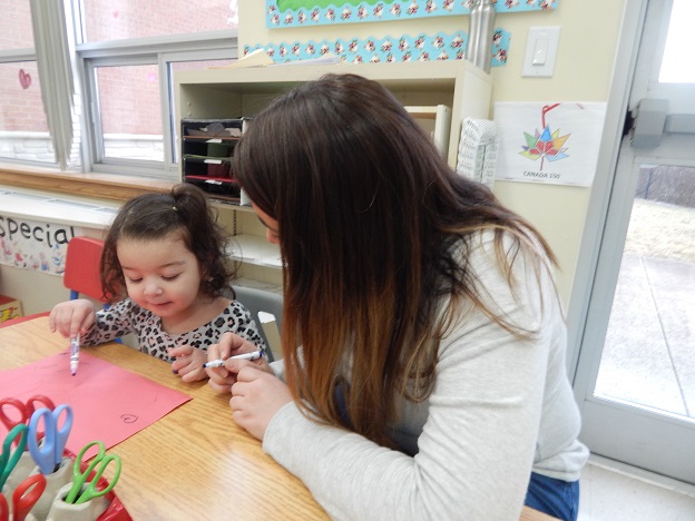 Mom works with child to develop early learning at Parent-Child Resource Centre